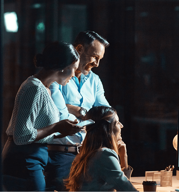 happy-business-people-night-with-computer-research-project-deadline-ideas-office-group-creative-employees-working-late-with-smile-technology-web-startup-workplace 1 (1)